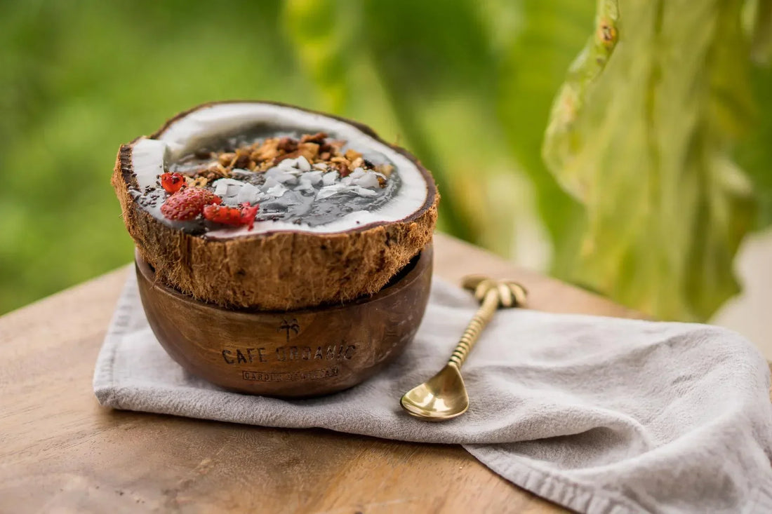 Fruit Smoothie bowl inside a freshly cut coconut from Cafe Organic in Bali. 