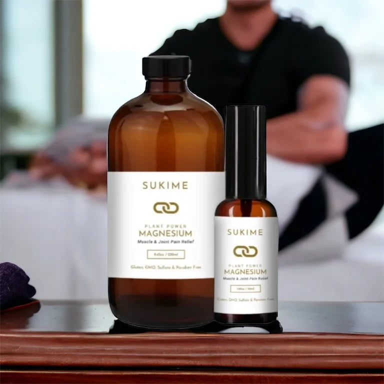 Sukime vegan magnesium oil in amber glass bottles with man giving massage in background